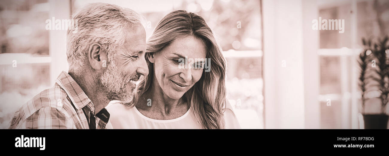 Couple looking in laptop on table Stock Photo