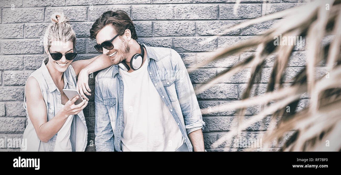 Young couple using mobile phone Stock Photo