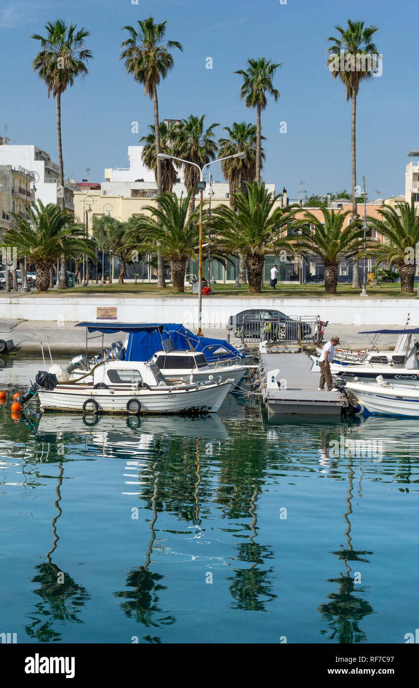 Fishing boats in the fishermen's harbour with the modern city of Corinth in the background, Northern,  Peloponnese. Greece Stock Photo