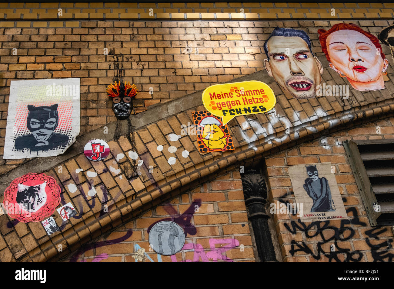 Berlin, Mitte, Street art and graffiti faces on brick elevated railway viaduct in Dircksenstrasse Stock Photo