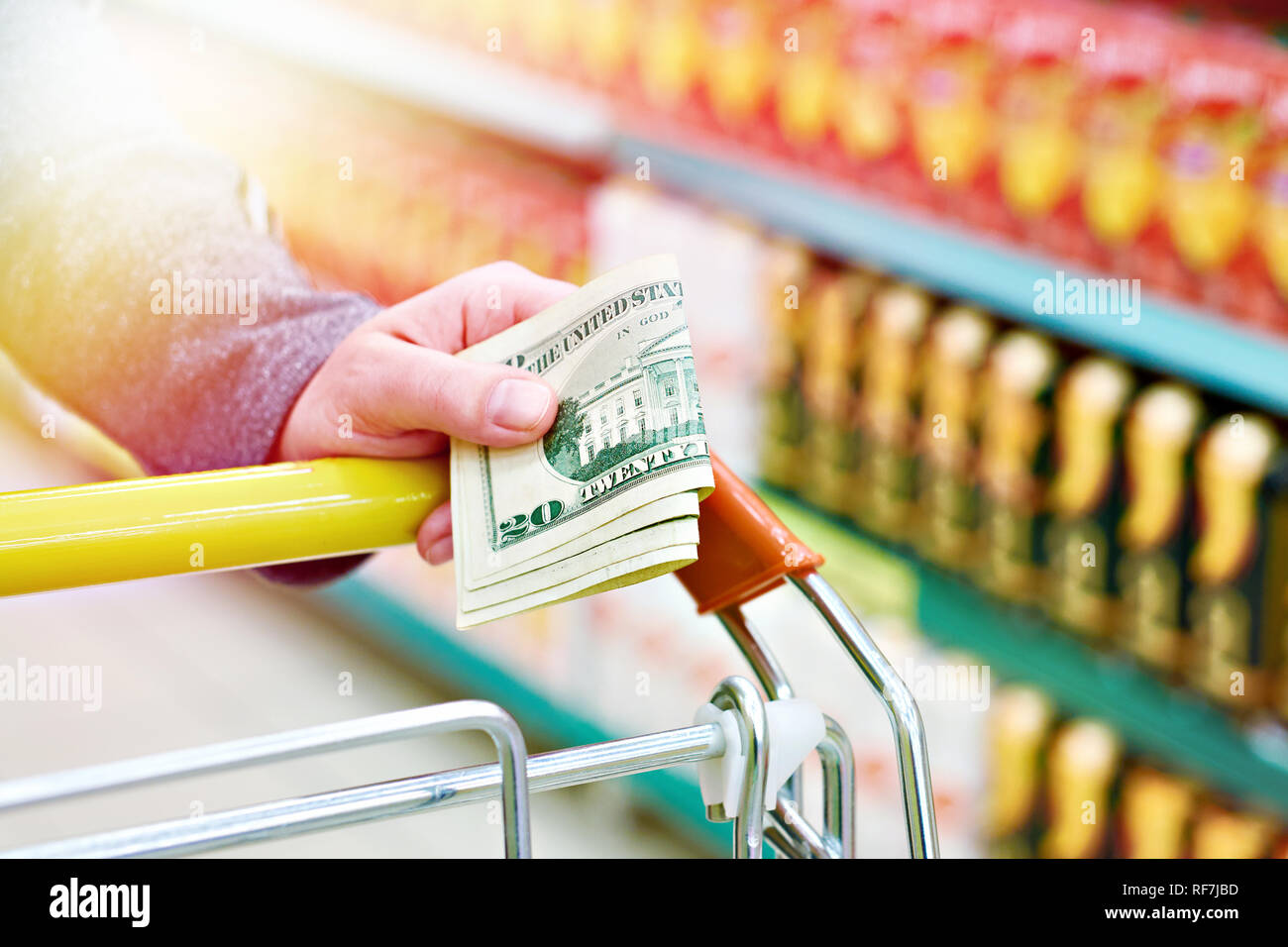 Dollar bills in the buyers hand in the store Stock Photo