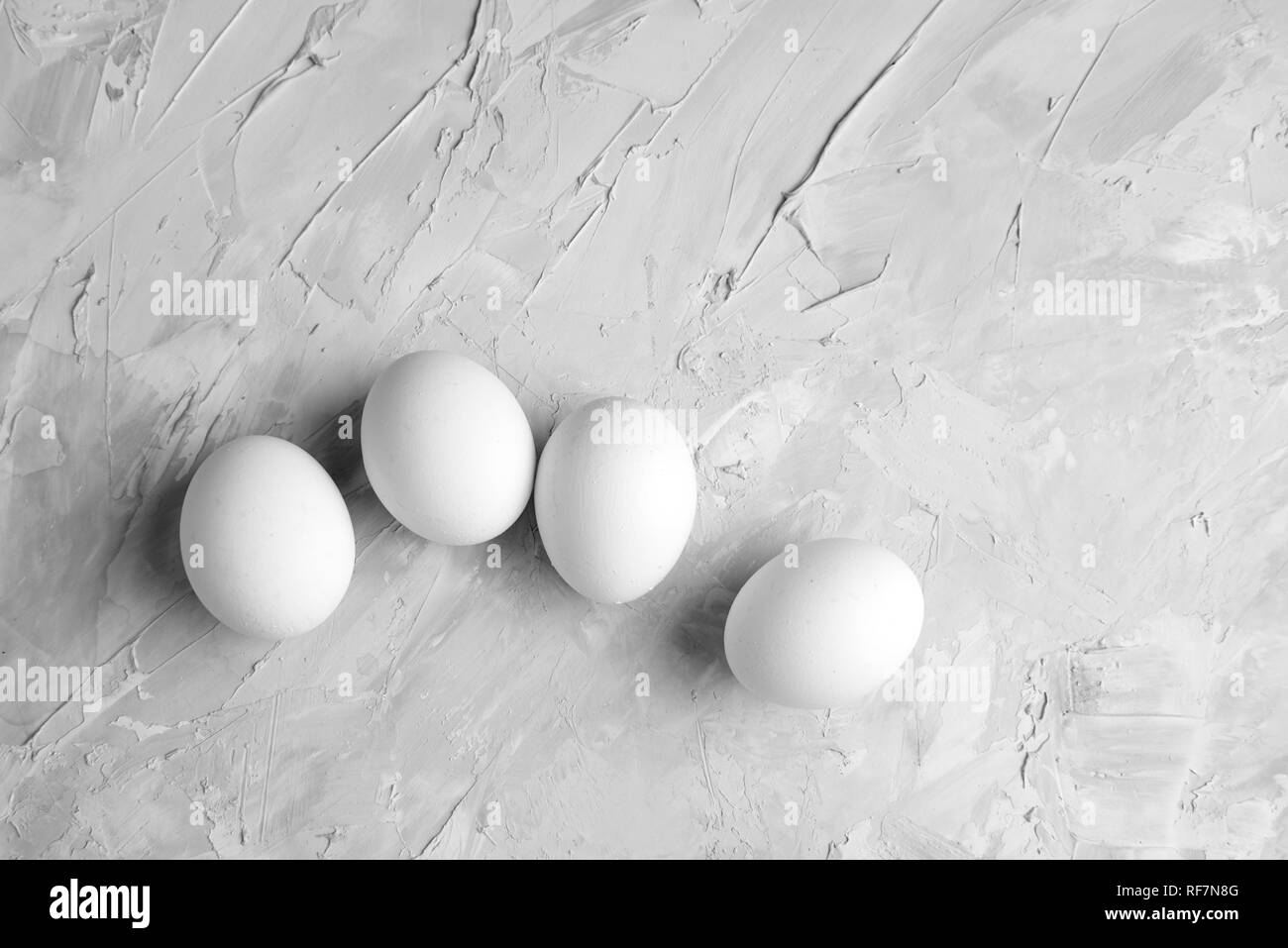 Chicken white eggs on concrete grey background top view poultry food concept Stock Photo