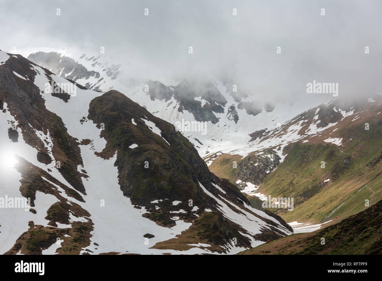Passo del San Gottardo or St. Gotthard Pass summer misty landscape (Switzerland). Rainy weather Stock Photo
