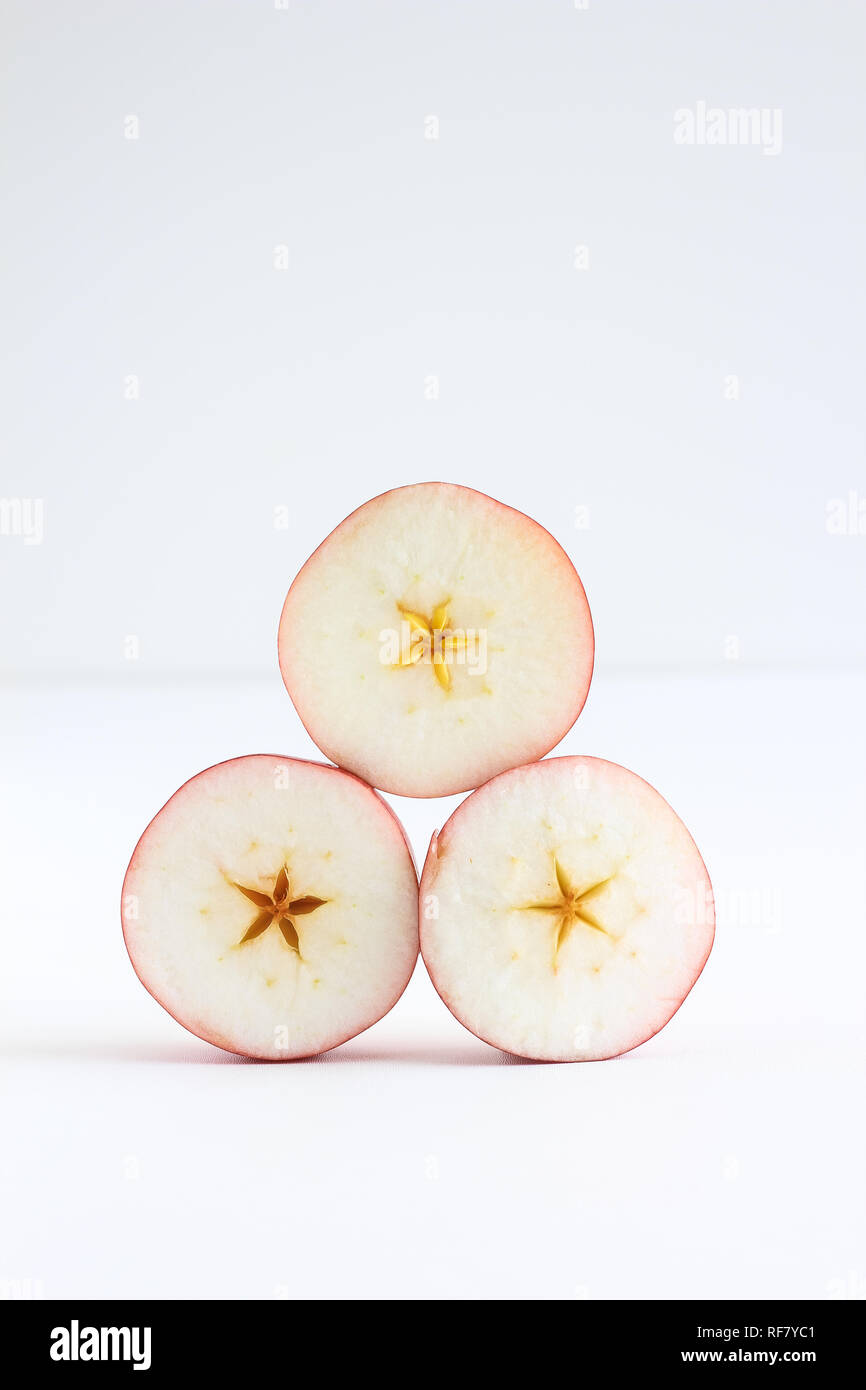 Stacked sliced pieces of apple on a white background Stock Photo