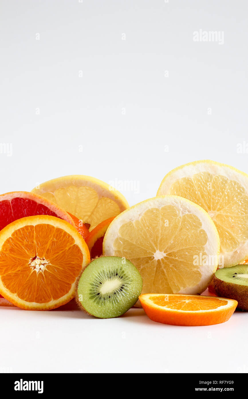 Layers of sliced fruits - kiwi, orange and grapefruits, close up Stock Photo