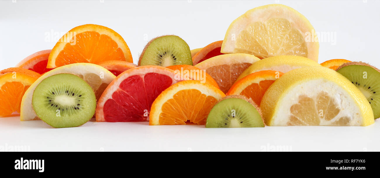 Layers of sliced fruits - kiwi, orange and grapefruits, panoramic crop Stock Photo