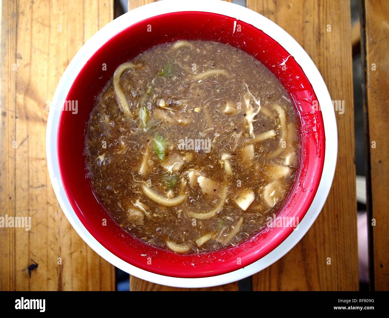 Photo of a bowl of freshly cooked fat egg noodles in thick soup known