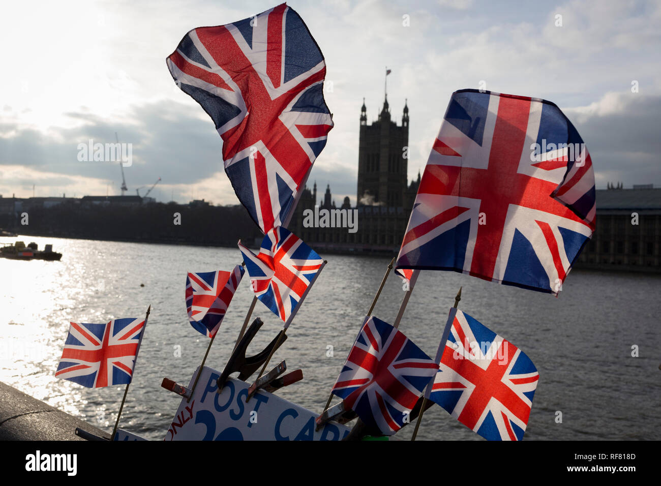 Flying British Union Jack flags and the UK's Houses of Parliament in front of the Thames River, on 21st January 2019, in London England. Stock Photo