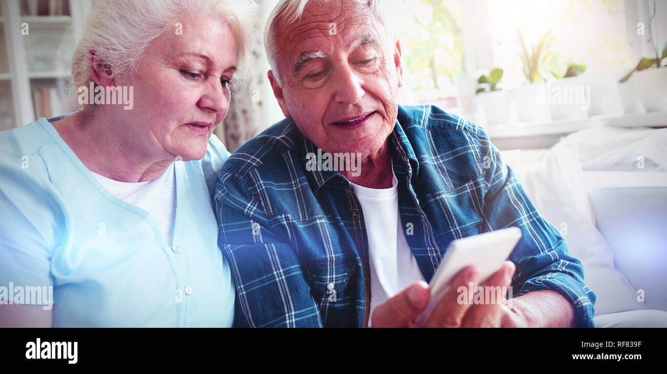 Senior couple using mobile phone Stock Photo