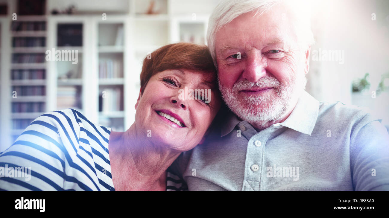 Senior couple sitting on sofa Stock Photo