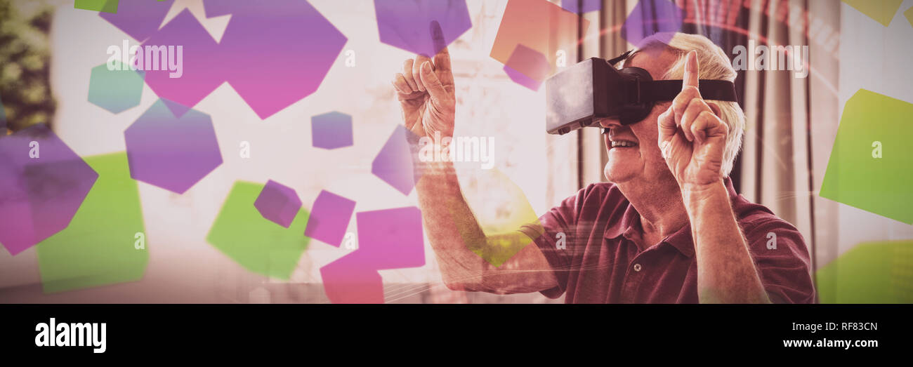 Senior man using a virtual reality device Stock Photo