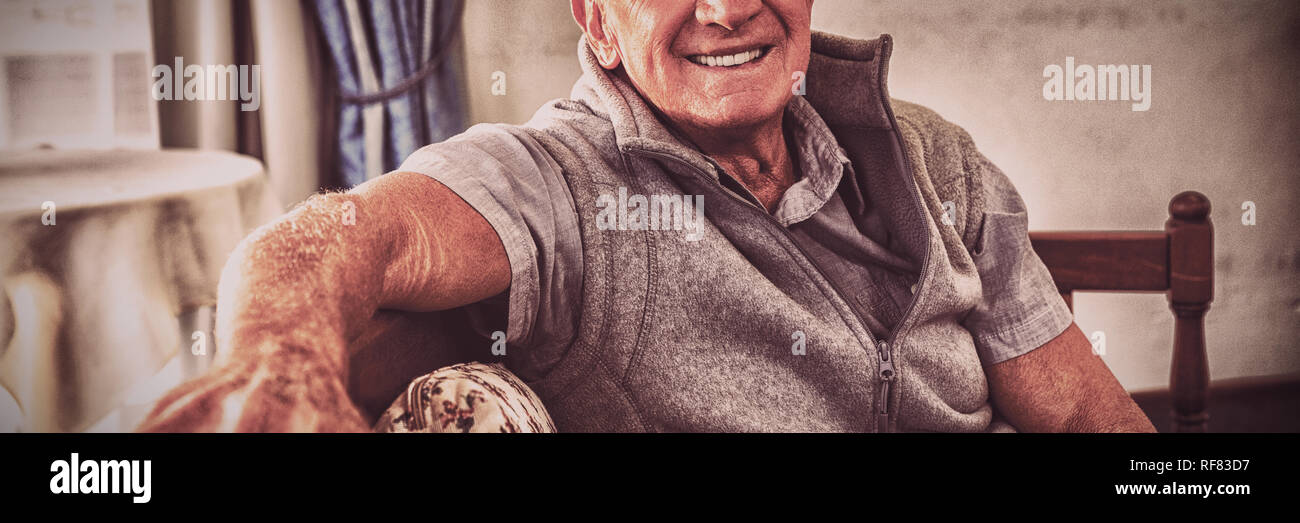 Man sitting couch smiling hi-res stock photography and images - Alamy