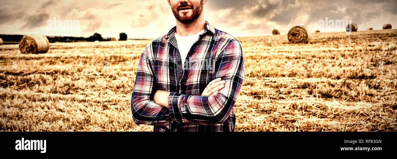Portrait of farmer standing with arms crossed in the field Stock Photo ...