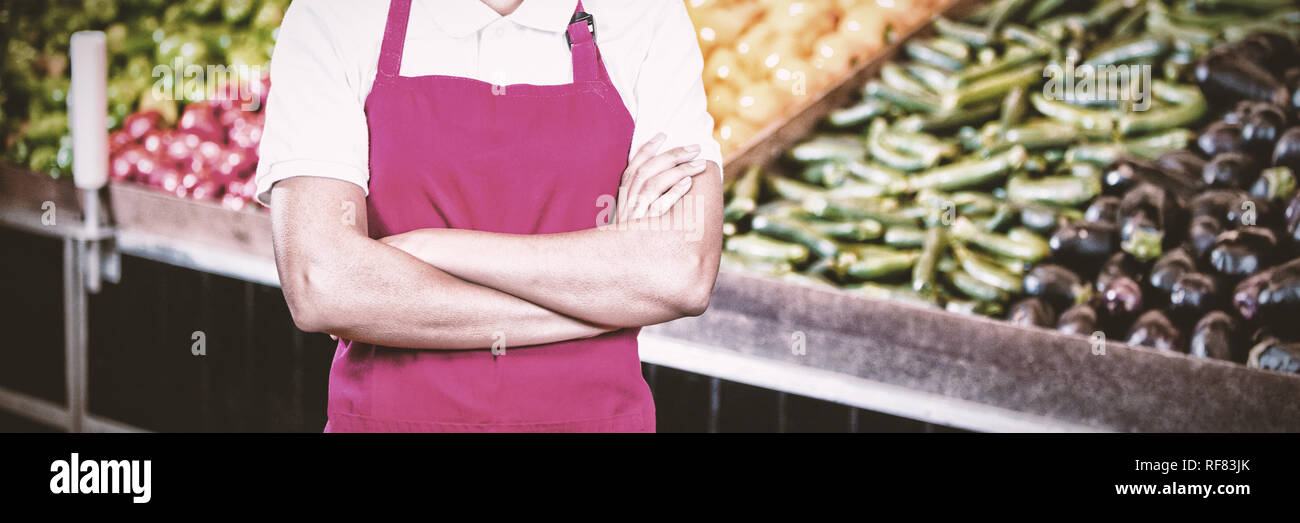 Portrait of smiling female staff standing with arms crossed in organic section Stock Photo