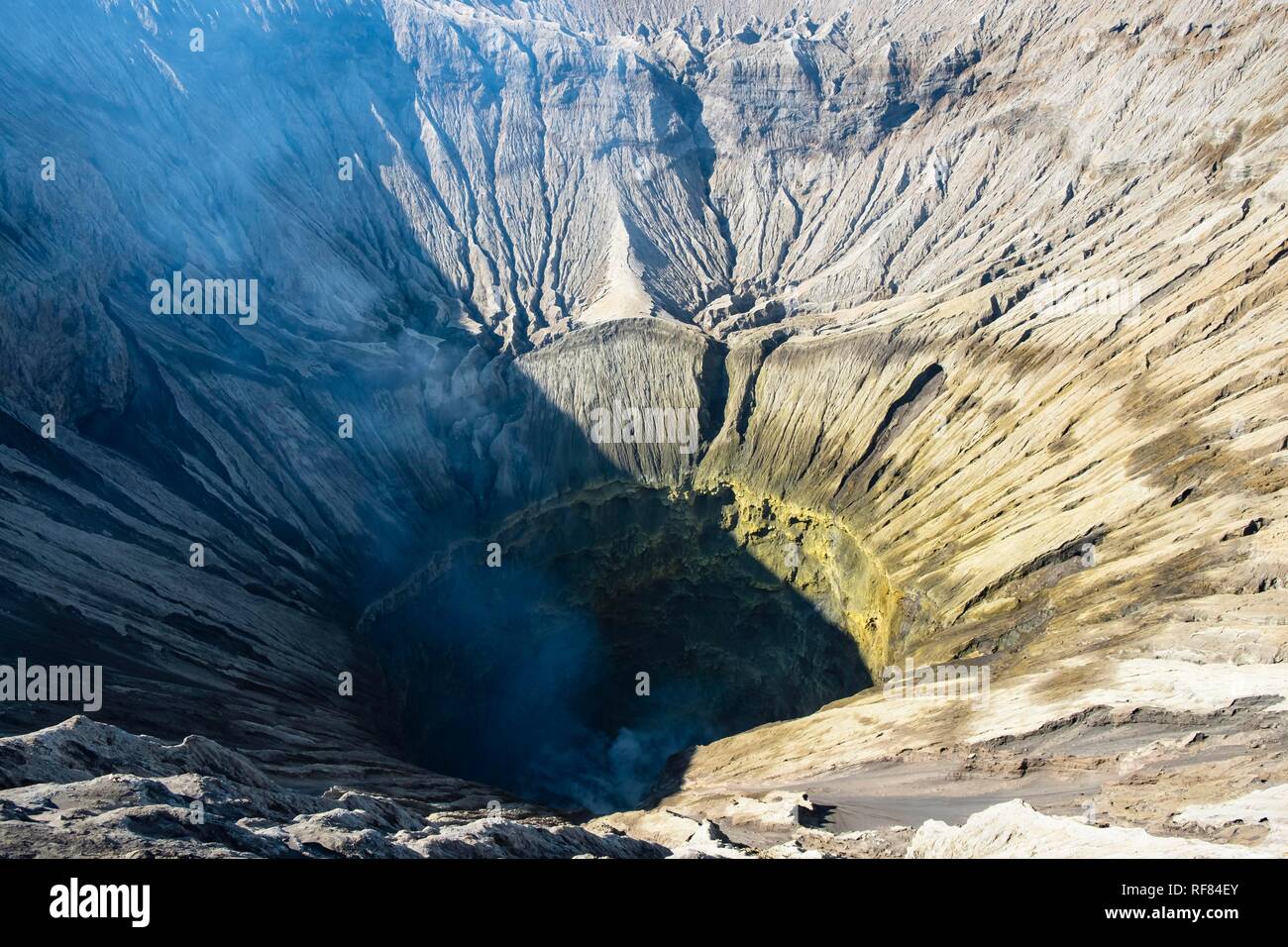 Crater, steam from volcano Gunung Bromo, Mt. Gunung Semeru, National Park Bromo-Tengger-Semeru, Java, Indonesia Stock Photo