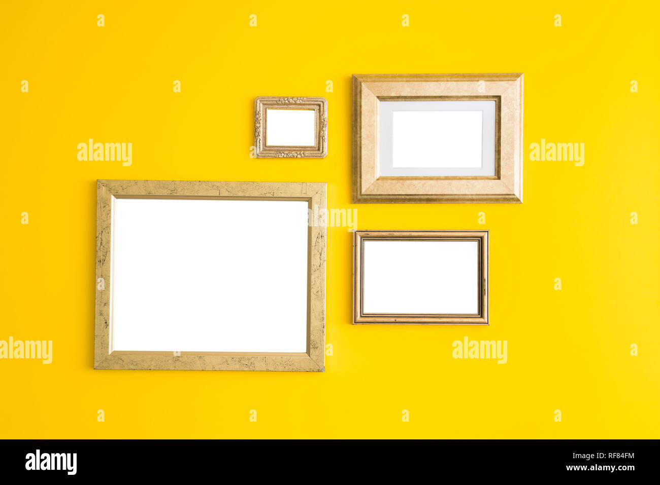 Blank empty golden, wooden frames on yellow background. Art gallery ...