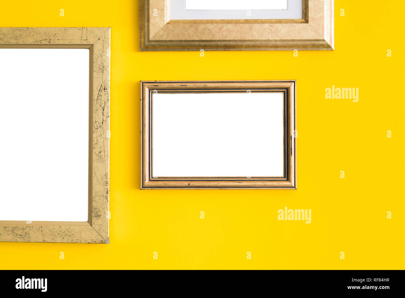 Blank empty golden, wooden frames on yellow background. Art gallery ...