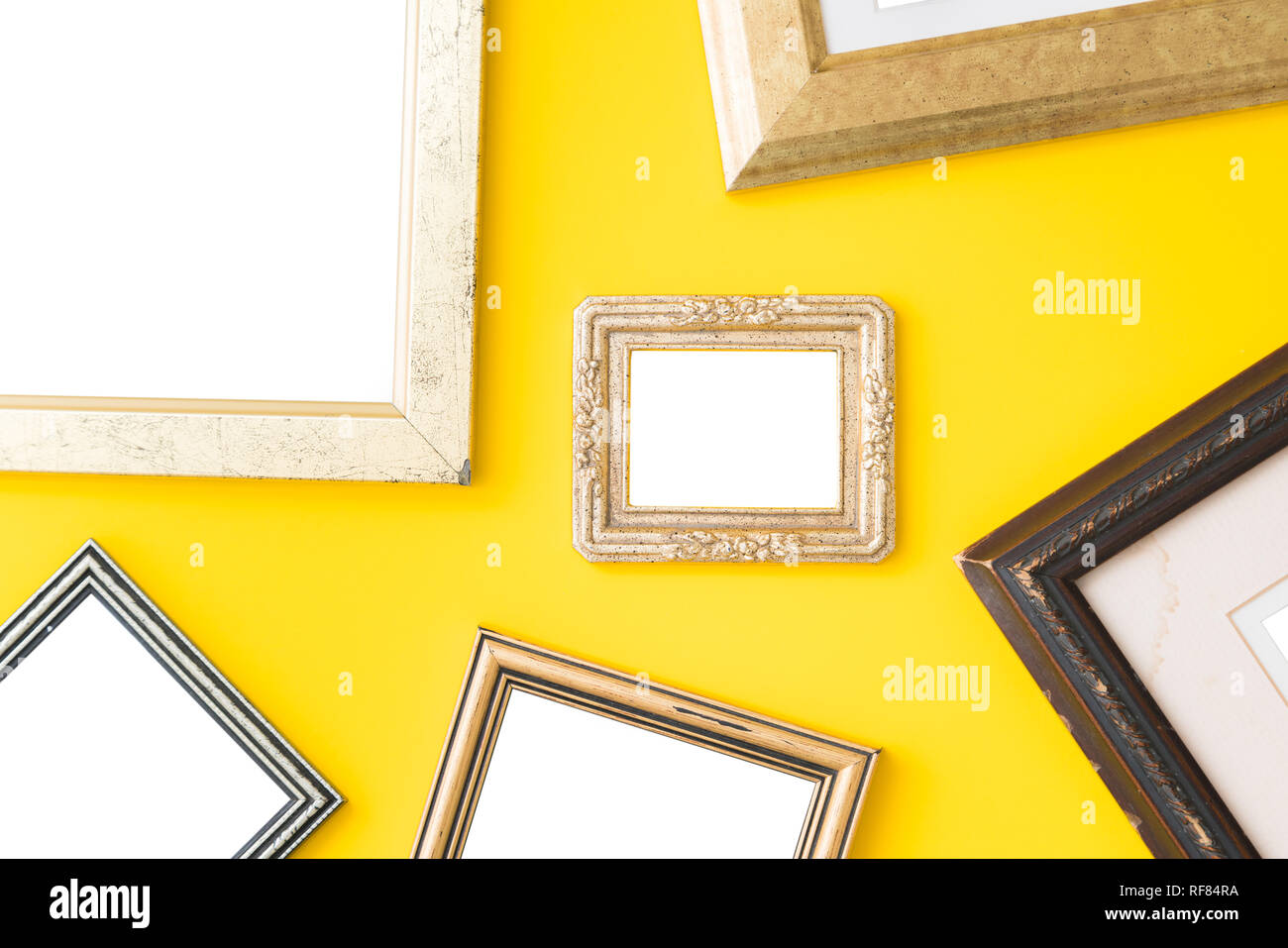 Blank empty golden, wooden frames on yellow background. Art gallery ...