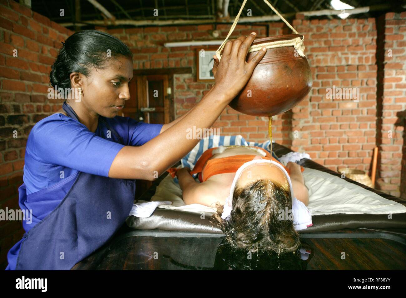 Shirodhara, gently pouring oils over the forehead (the 'third eye'), Somatheeram Ayurveda Resort, traditional Ayurvedic medicine Stock Photo