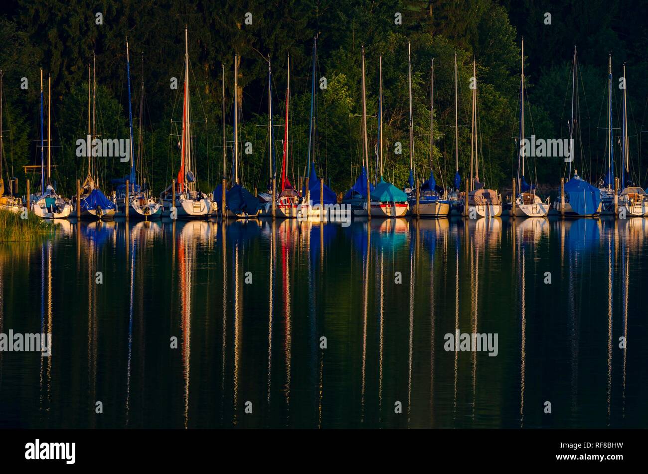 Sailboats with reflection in water, feet, Bavaria, Germany Stock Photo