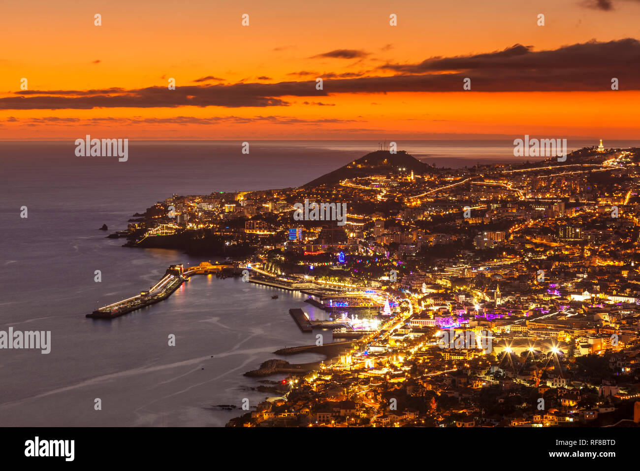 Funchal madeira Funchal skyline at sunset looking across the bay port harbour and old town Funchal Madeira Portugal Europe Stock Photo