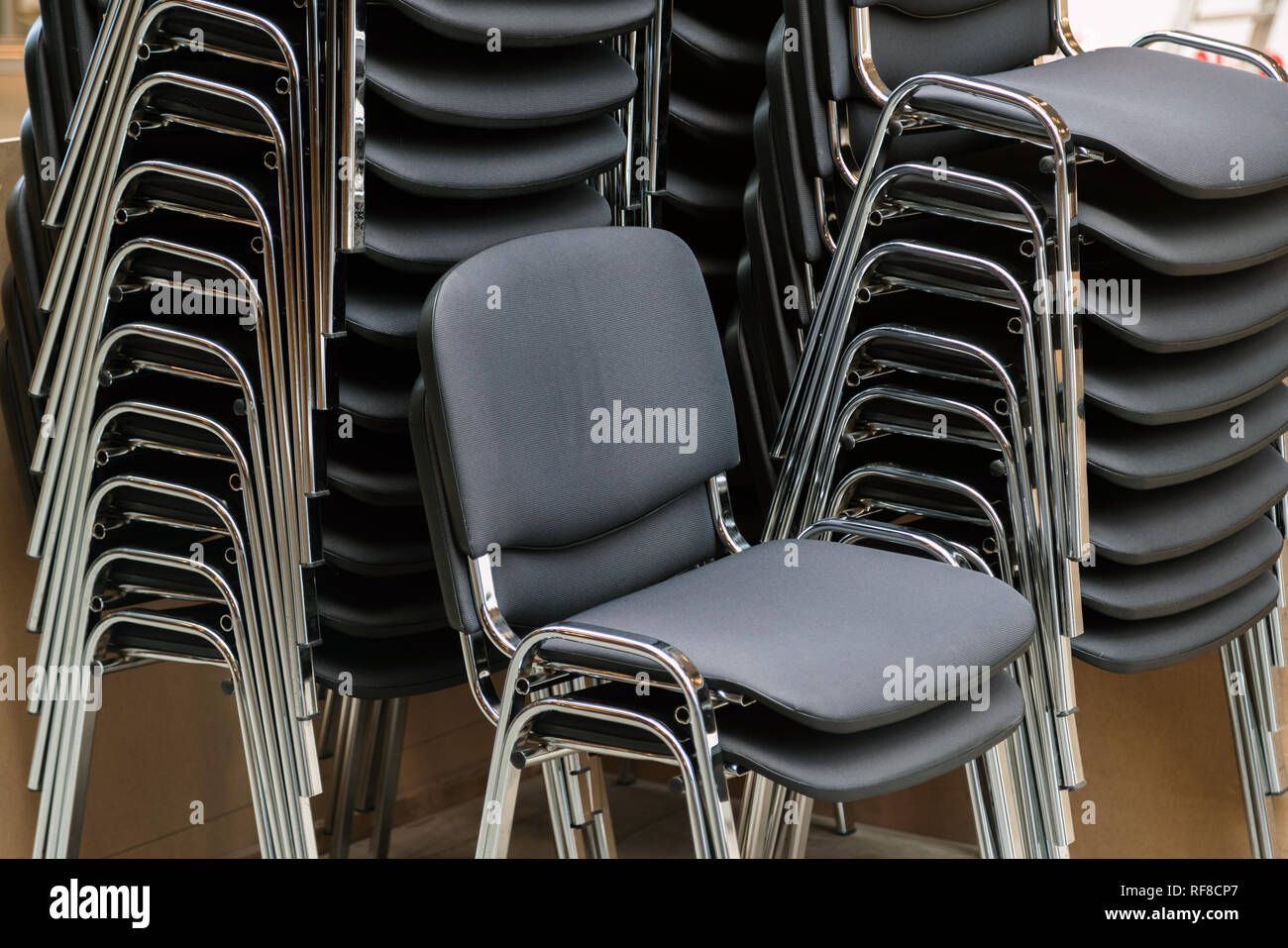 Leather and metal chairs stacked on top of each other in the meeting room Stock Photo Alamy