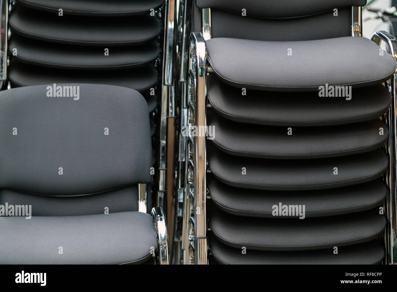 Leather and metal chairs stacked on top of each other in the meeting room Stock Photo Alamy