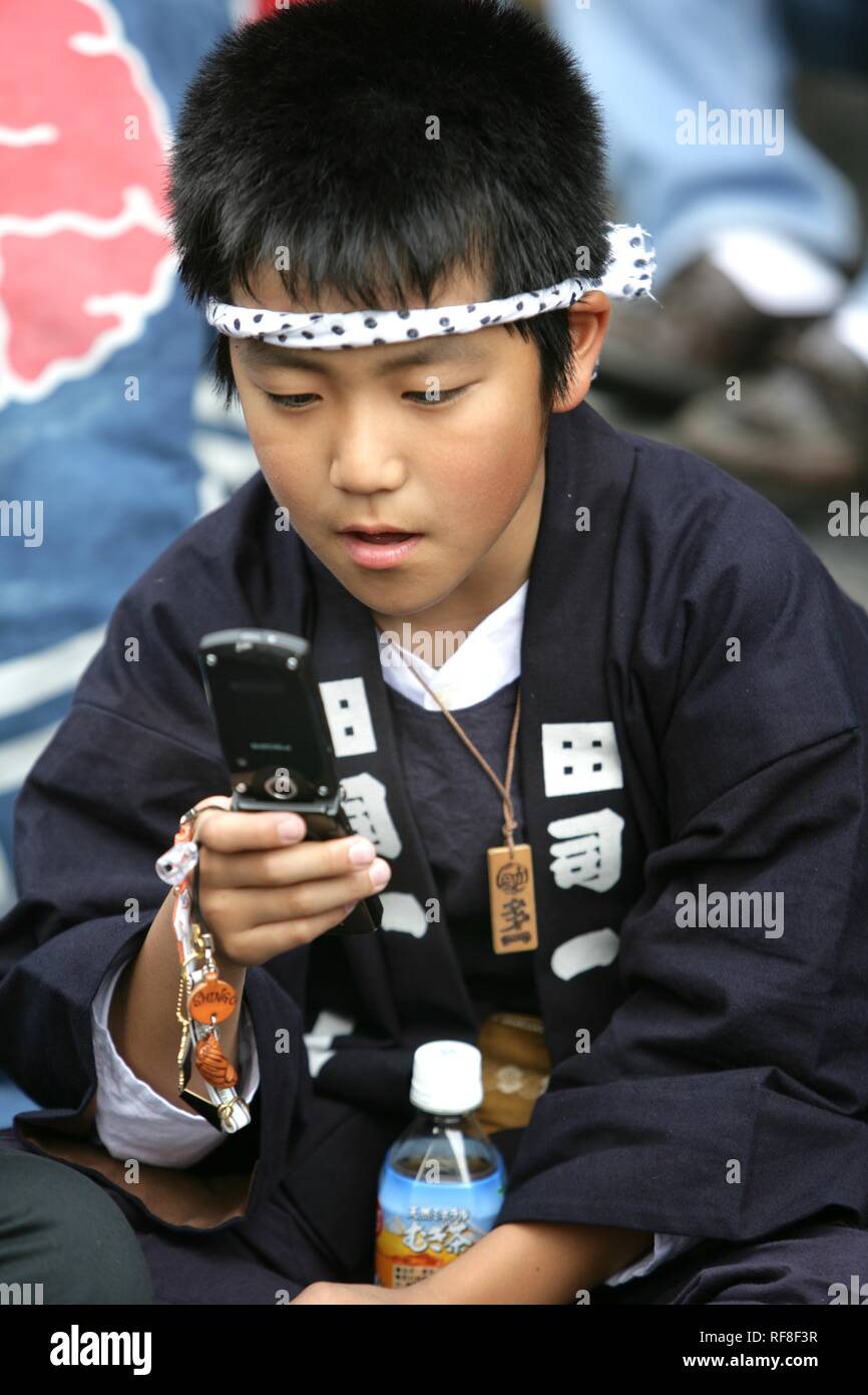 Japan, Tokyo: child with mobile phone during the Shrine festival, called Matsuri Stock Photo