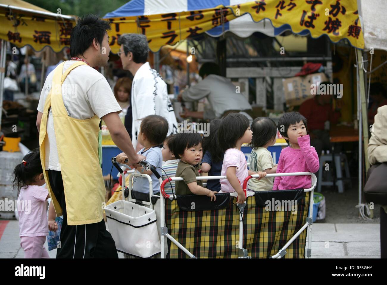 Kindergarten children in a huge stroller on a class trip in Tokyo, Japan, Asia Stock Photo