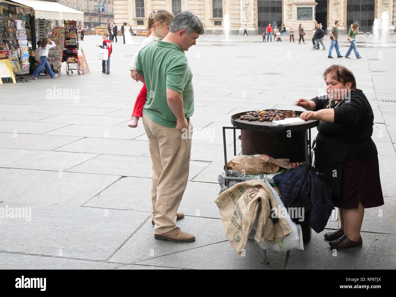 Woman with dwarfism selling sweet chestnuts in Turin, Piedmont, Italy, Europe Stock Photo