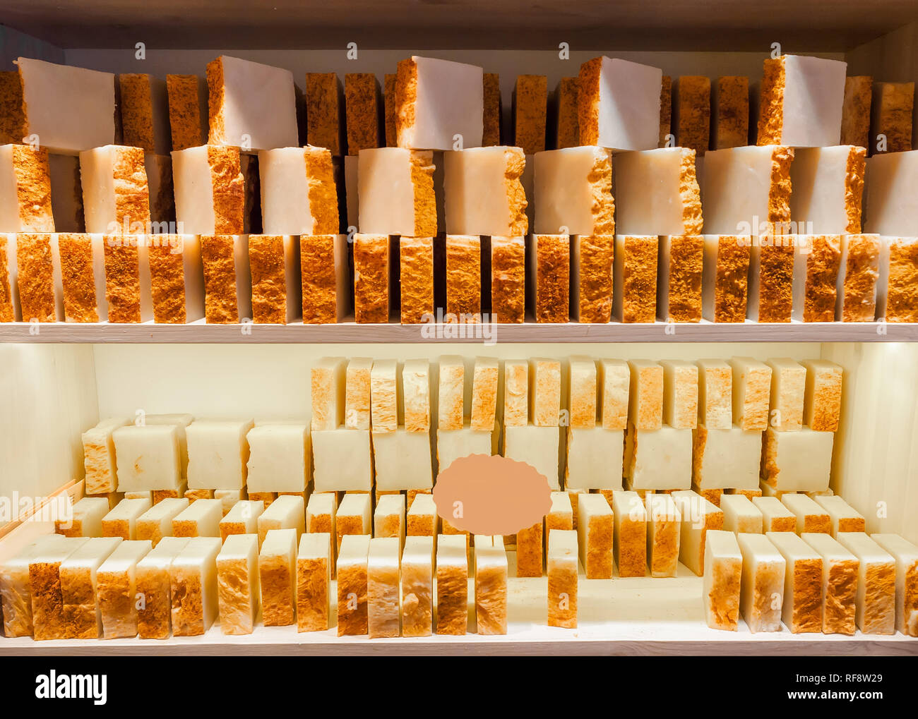 Bars of soap on a shop window. Turmeric soap with natural cedar oil and