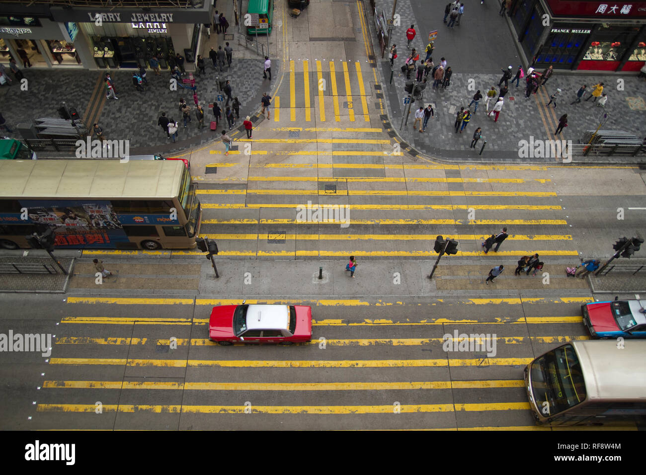 High view down to street crosing yellow markings Hong Kong vehicles