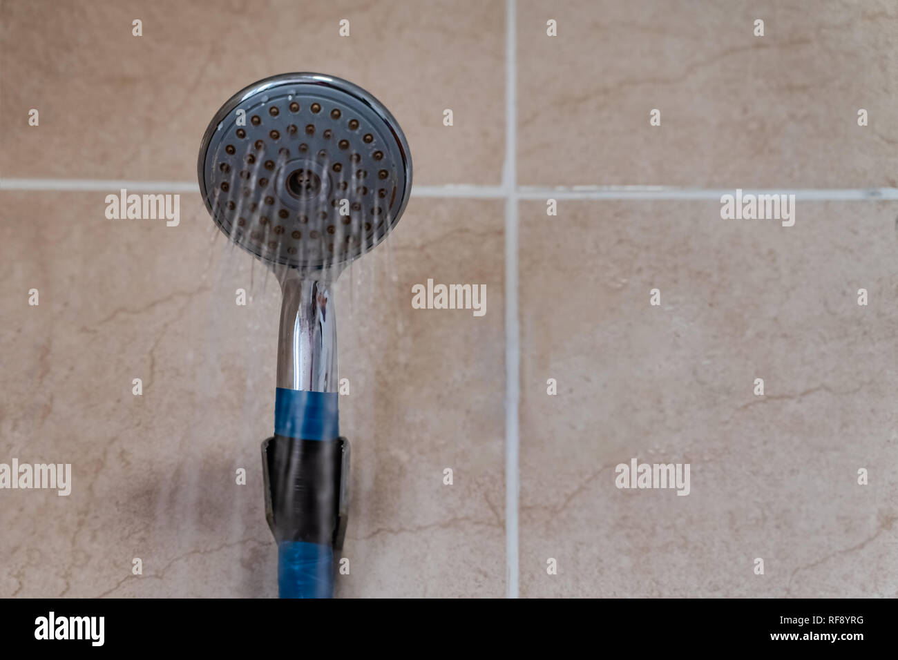Under the shower jet picture taken from below of a shower spraying