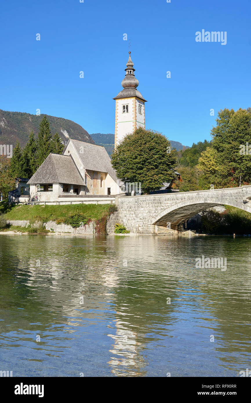 The Church of St John the Baptist, Cerkev Sv. Janeza Krstnika, and Lake Bohinj, Ribcev Laz, Bohinj, Gorenjska, Slovenia. W Stock Photo
