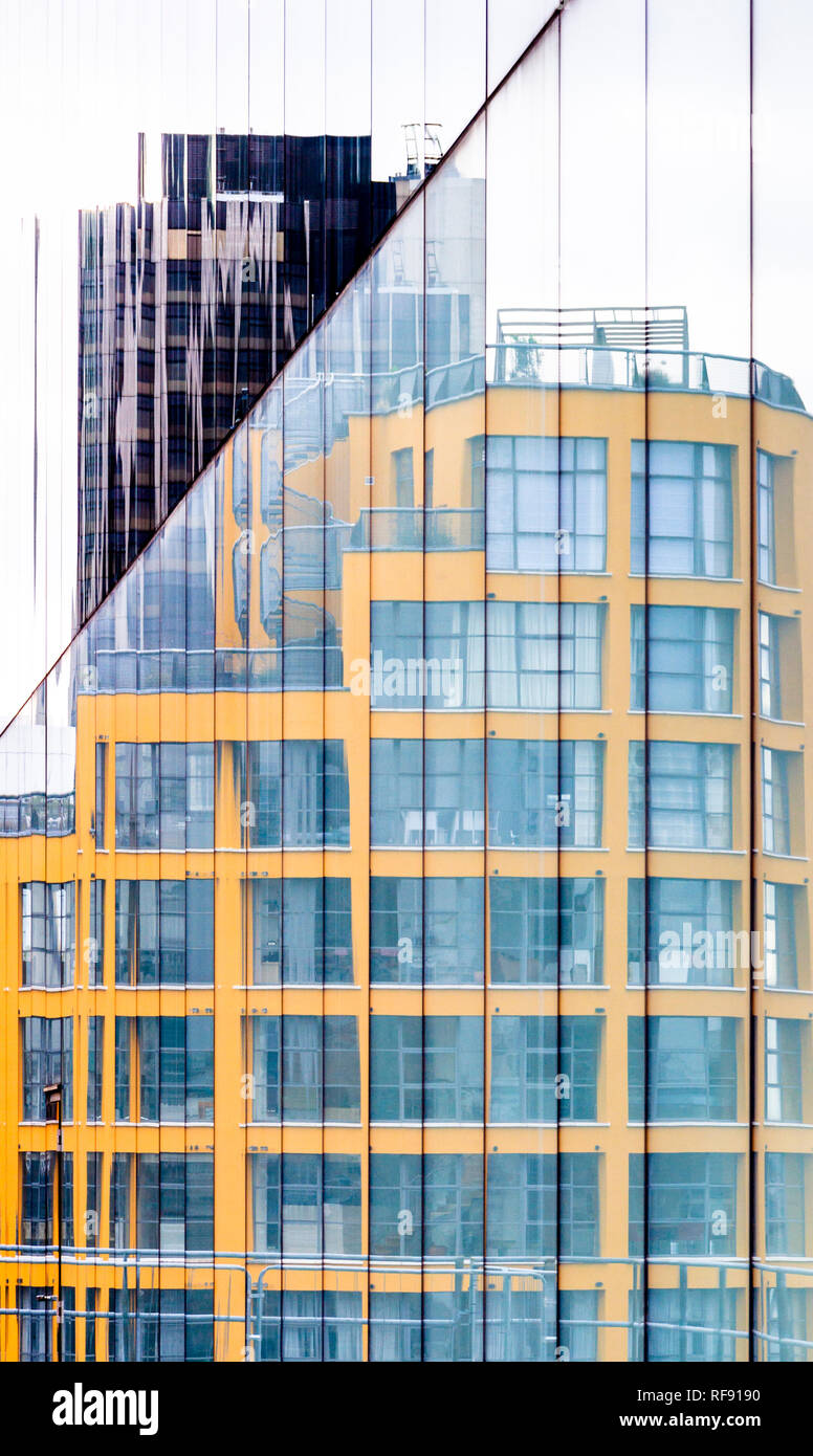 A glass fronted office building reflected in the glass façade of another, Central London, UK Stock Photo