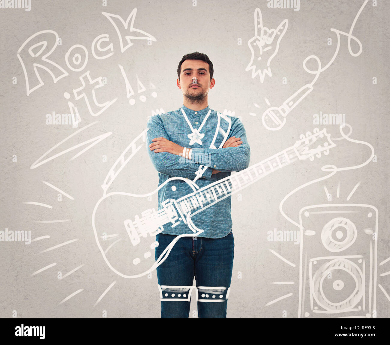 Confident young man arms crossed imagine him as a musician with a guitar performing on stage. Dream come true as sketches on the background. Rock star Stock Photo