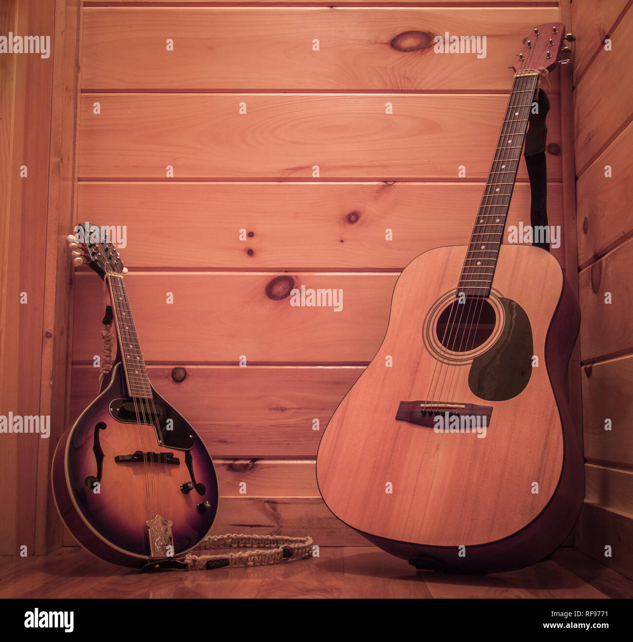 Mandolin and guitar with a rustic wooden cabin background Stock Photo