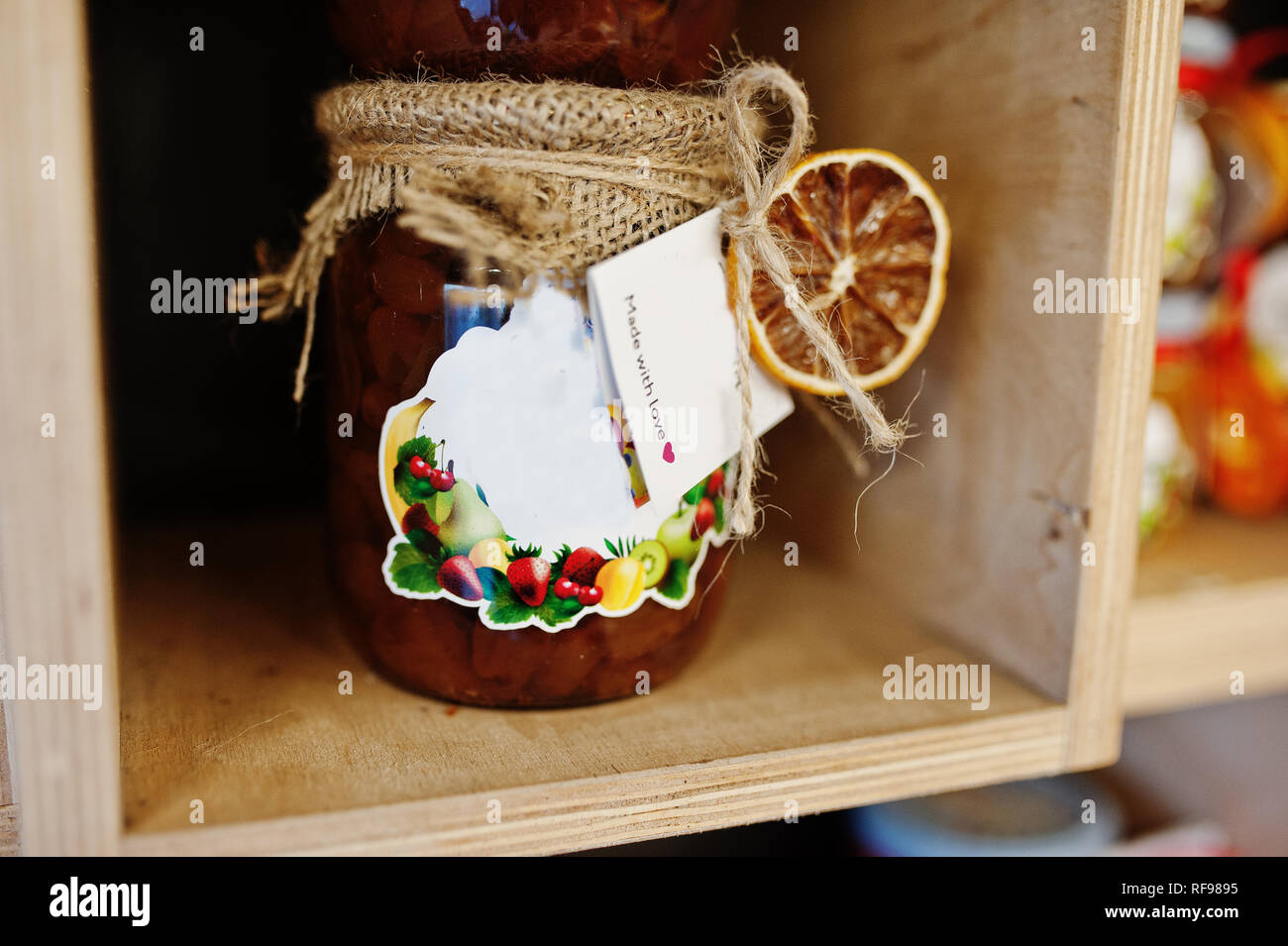Glass jars with different kinds of jam and berries of a supermarket