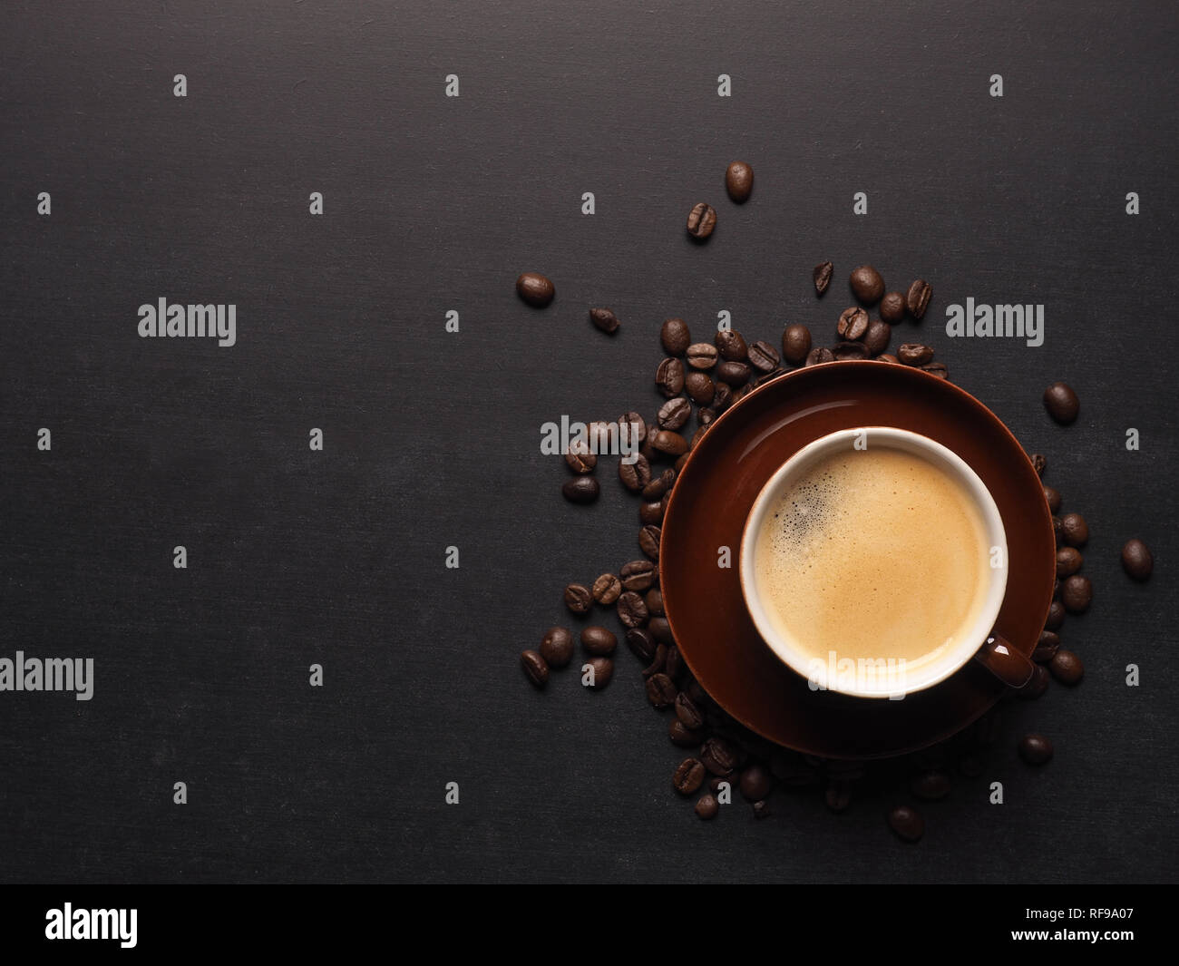 Cup of an espresso with coffee beans on a chalkboard, space for text or