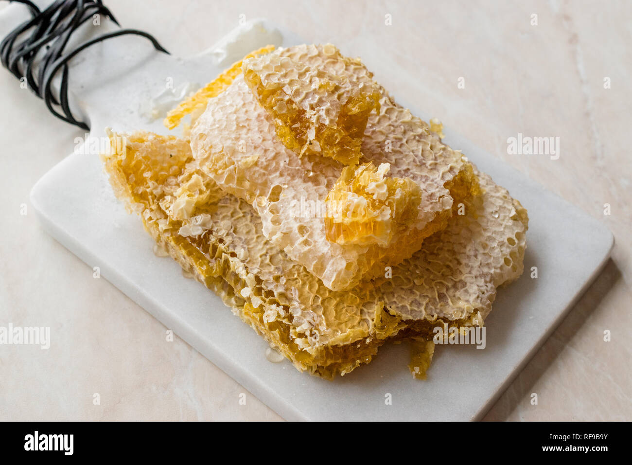 Fresh Slices with Honey on Marble Board. Organic Food Stock
