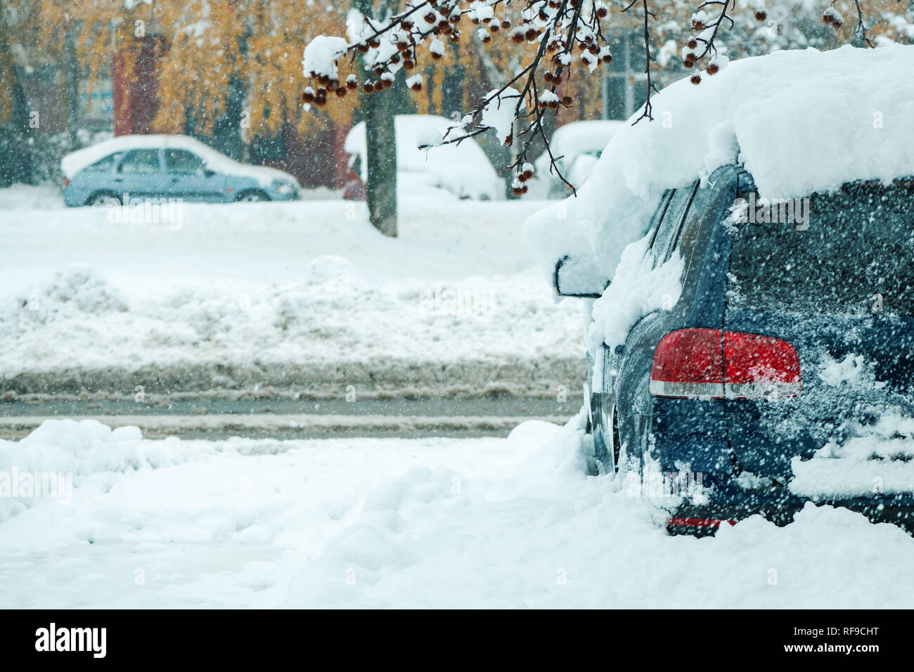 Automobile parking lot with cars covered in snow, parked vehicles in