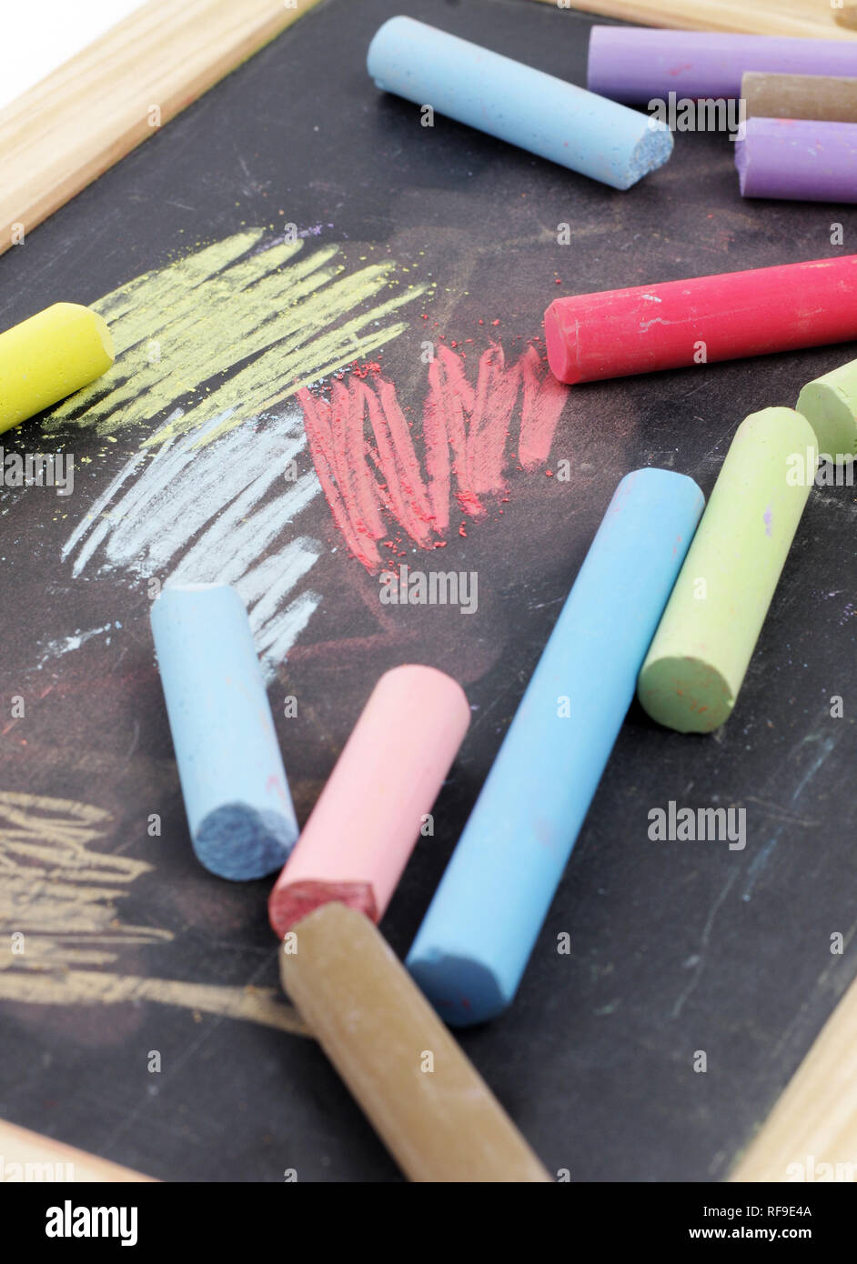 Colorful chalks and black chalkboard Stock Photo Alamy