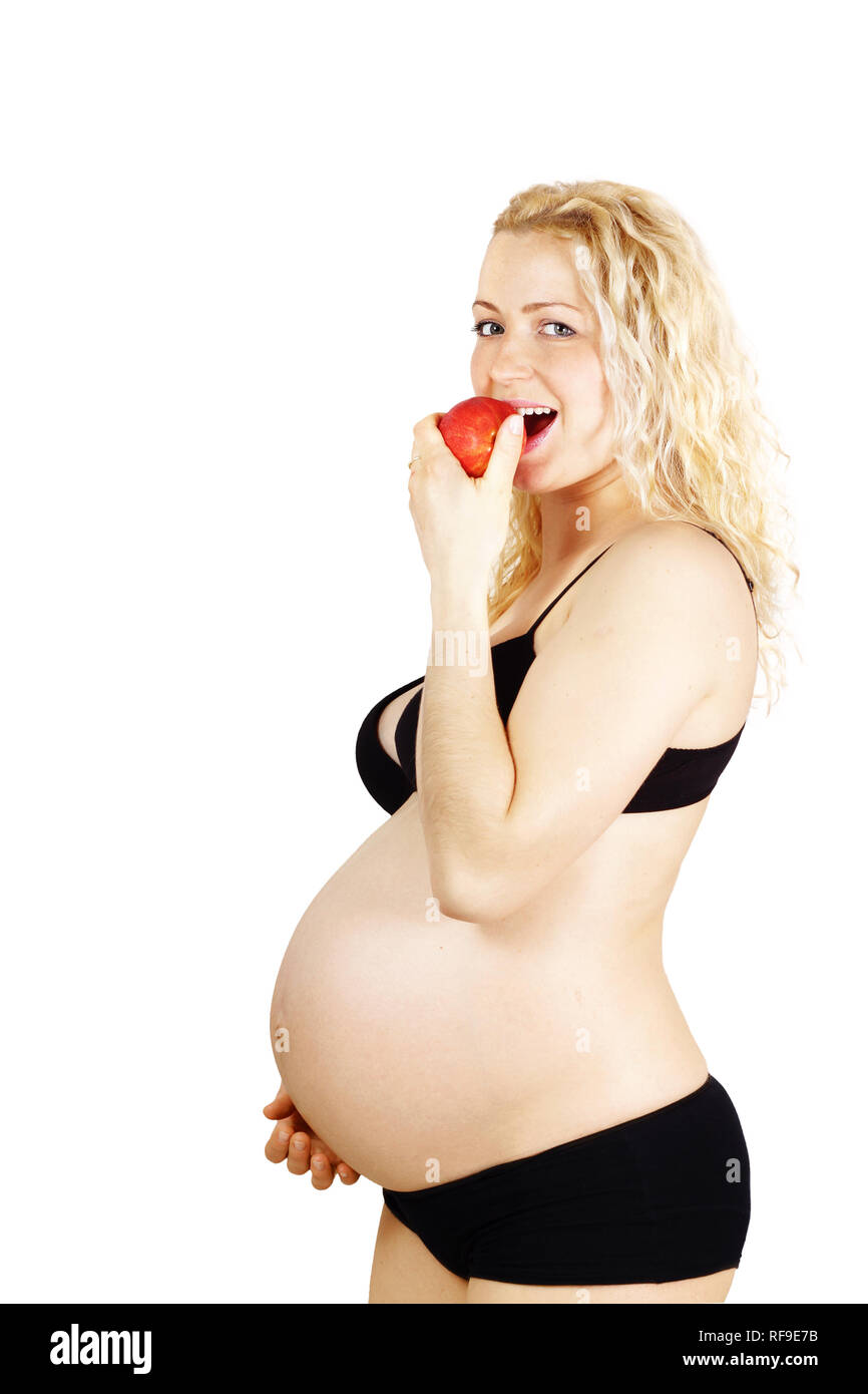 Beautiful pregnant woman eating red apple, isolated on white Stock