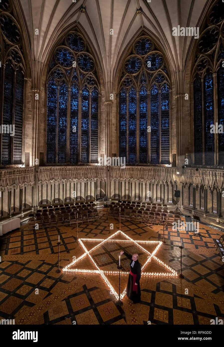 Canon Chancellor Christopher Collingwood helps light six hundred candles in the shape of the Star of David, in memory of more than 6 million Jewish people murdered by the Nazis in the Second World War, at York Minster in York. Stock Photo