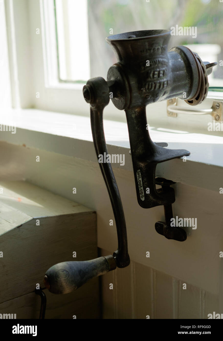 Vintage Cast Iron E.C. Simmons  Keen Kutter USA meat grinder attached to window sill. Stock Photo