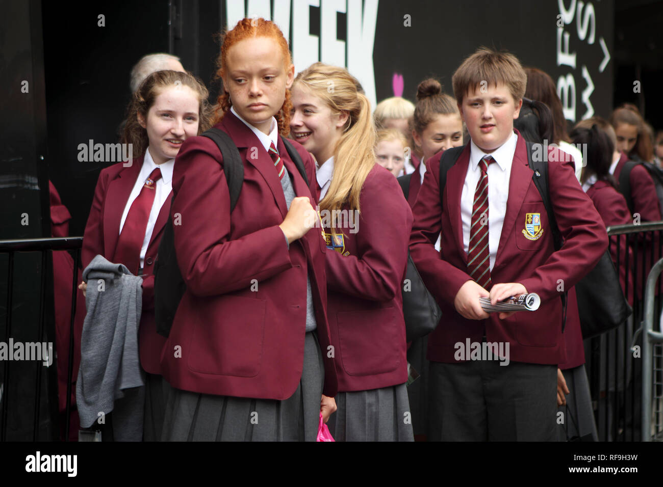 LONDON, UK- SEPTEMBER 14 2018: Schoolchildren in red school uniform waiting  for the teacher on the street Stock Photo - Alamy