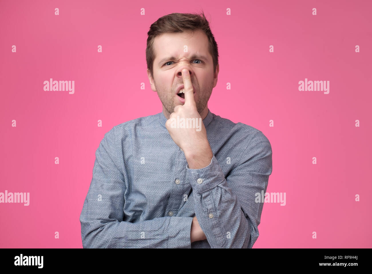 Man turns his nose up like pig. Stock Photo