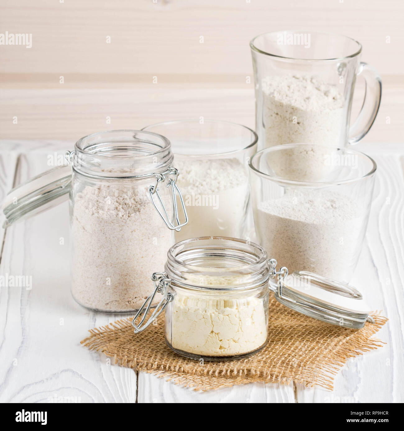 Different flour in glass jars, wheat, corn, rye, oats, spelt, flax