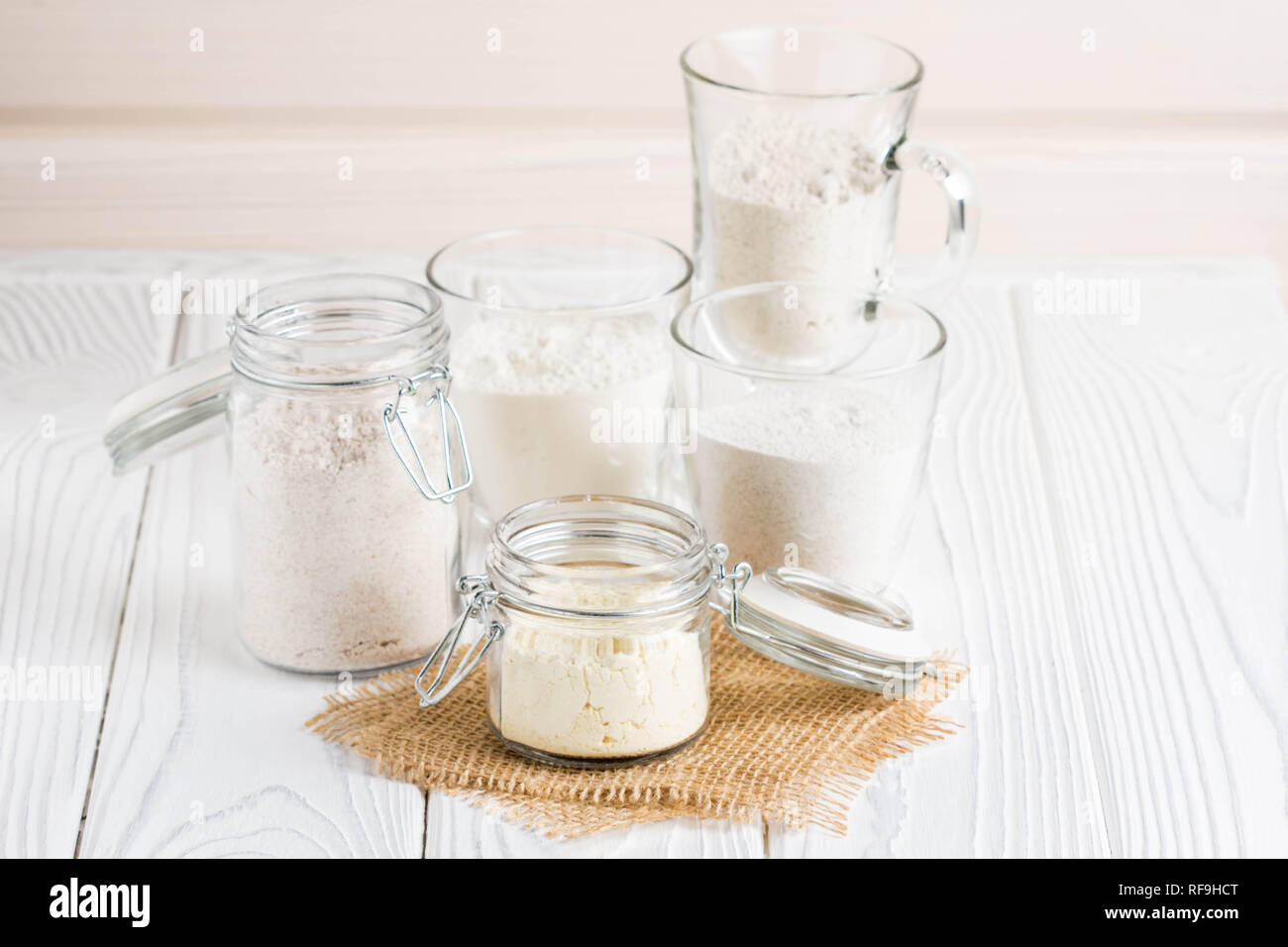 Different flour in glass jars, wheat, corn, rye, oats, spelt, flax