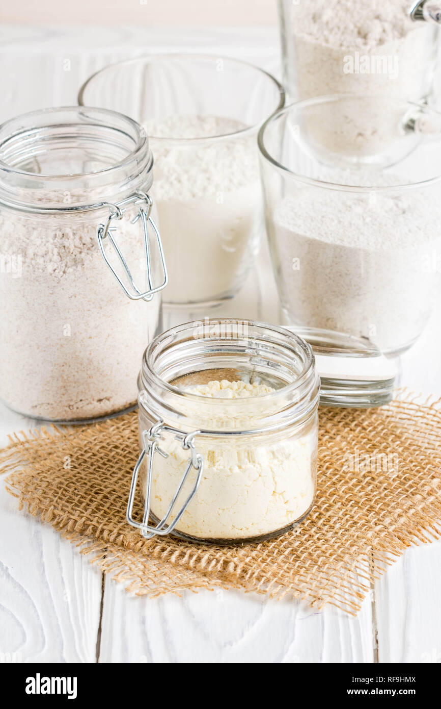 Different flour in glass jars, wheat, corn, rye, oats, spelt, flax